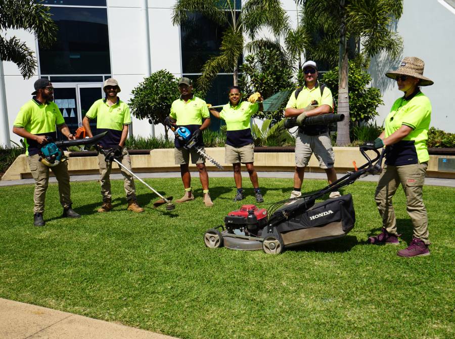 People standing on lawn with garden tools