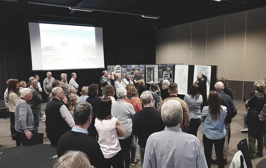 People viewing a presentation and plans for the 'The Spit Master Plan'