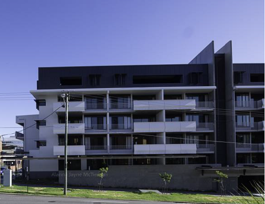 External view of the building, showing the basement carpark and street awning.