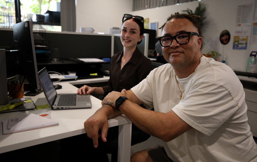 Caitlyn and youth foyer tenant looking at computer screen